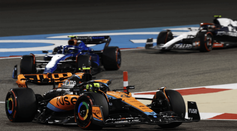 Three F1 race cars speeding, inches apart, battling for position on a sharp turn. The tension is high capturing the balance between risk and strategy in business.